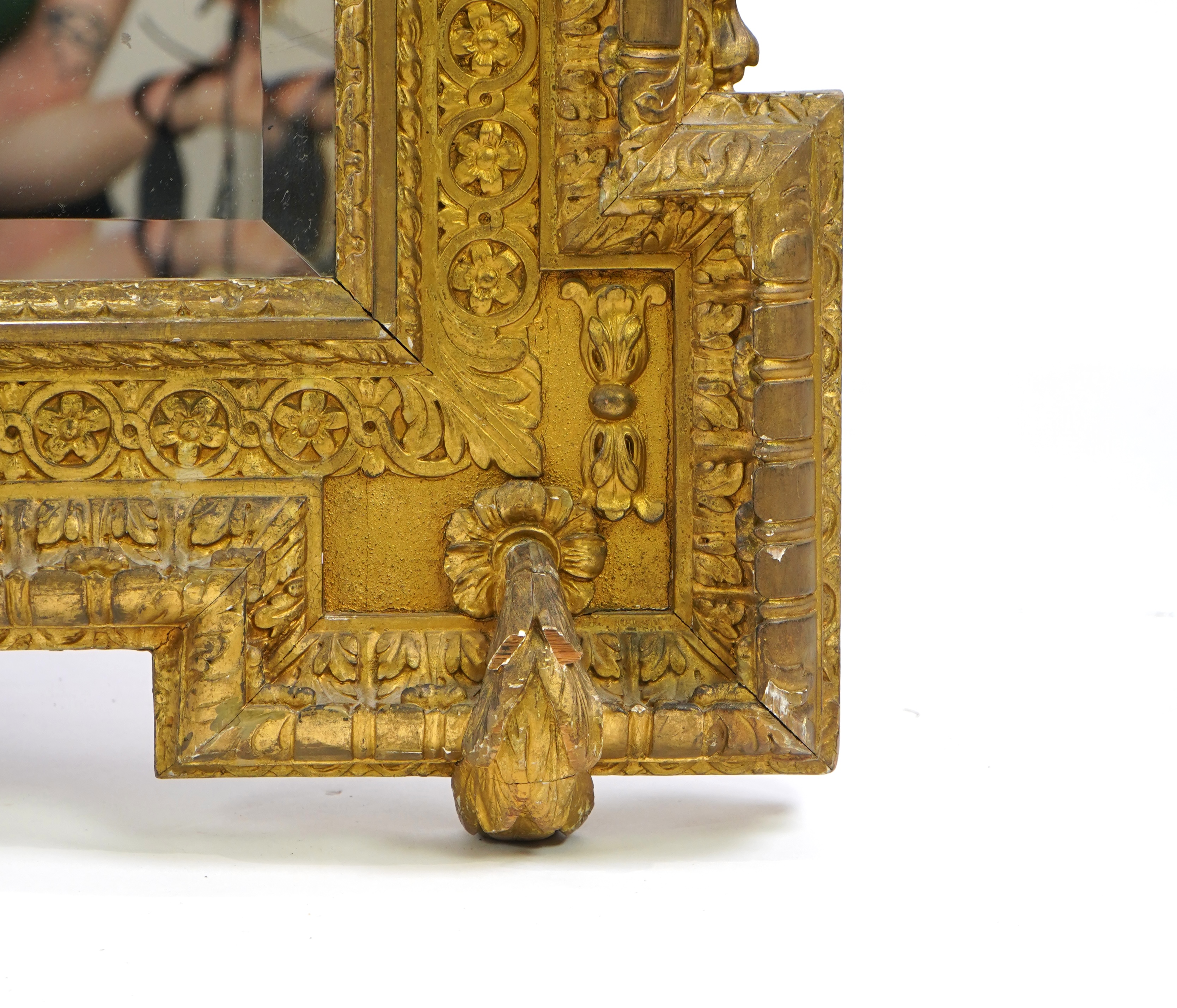 A late 19th century French carved gilt wood and composition overmantel mirror